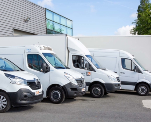 A fleet of different work vans