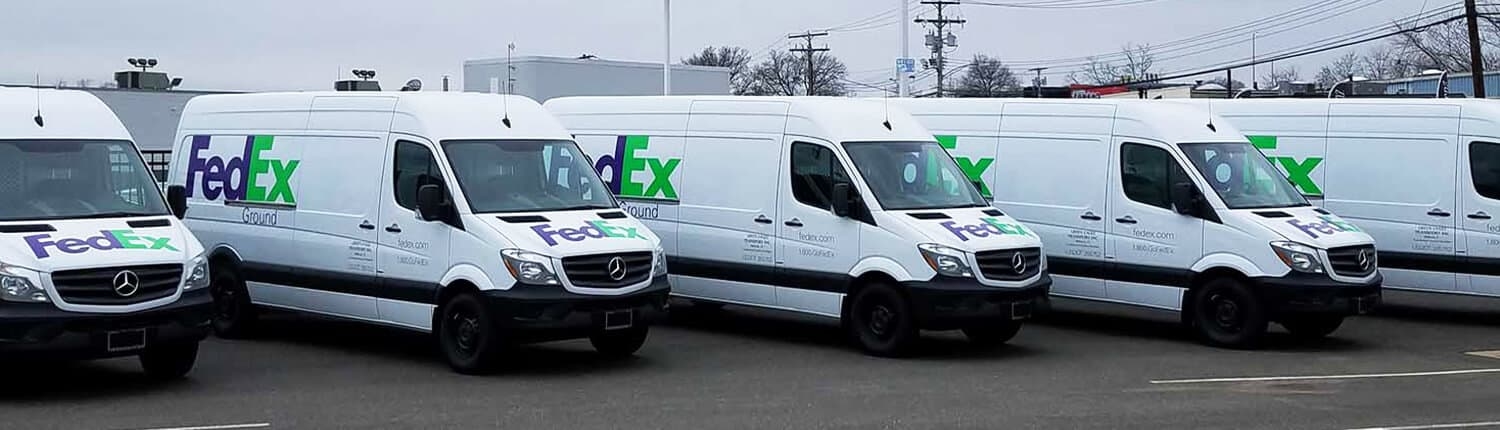 A fleet of FedEx Ground vans