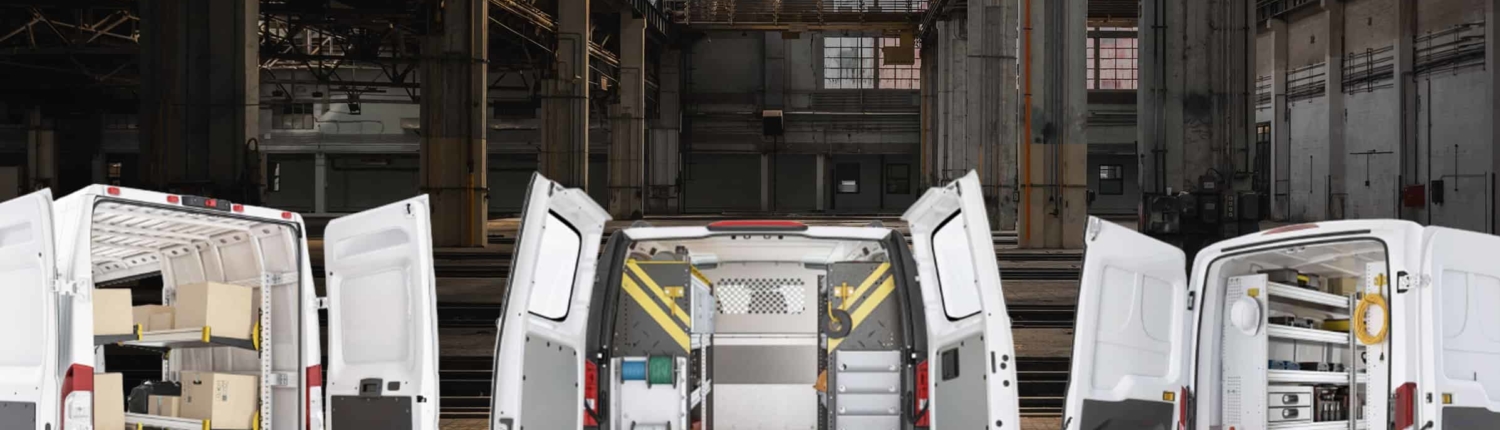 Three upfitted vans in a warehouse