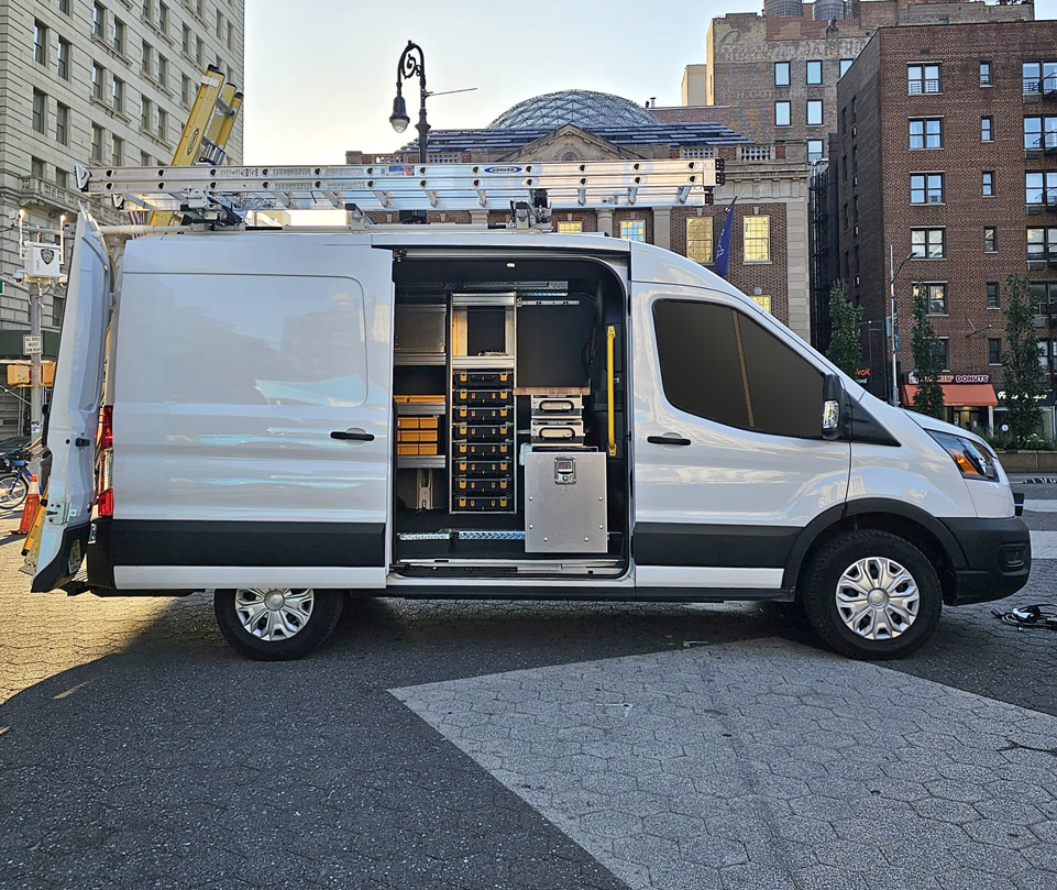 Customized white fleet van with interior shelving and storage