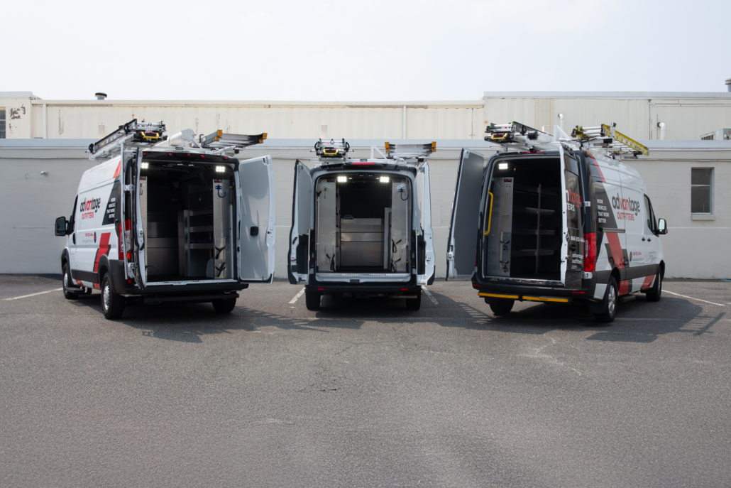 3 fleet vehicles lines up with the rear doors open to showcase the Packd shelving packages inside.
