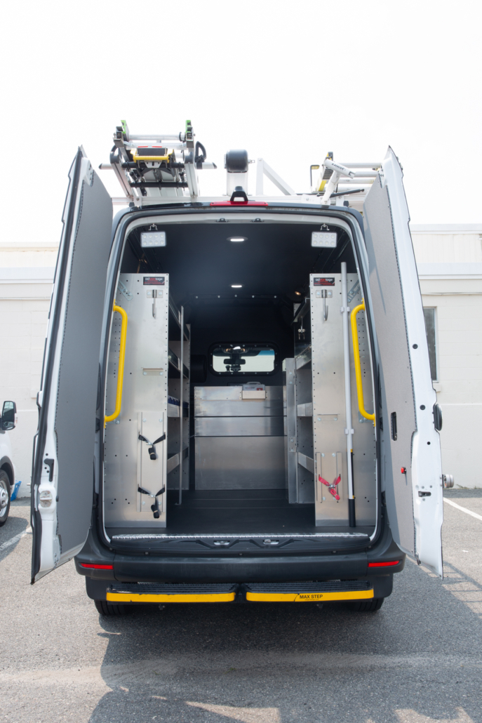 Packd shelving pckage in the back of a cargo van with the doors open.
